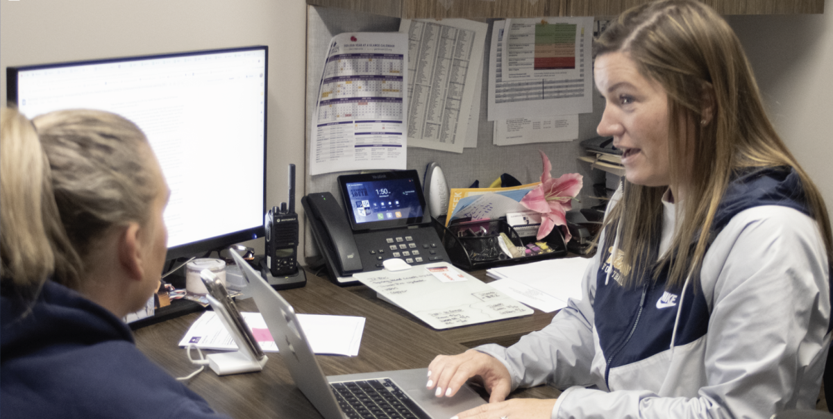 NEW ROLE, NEW LEADER: Courtney Middleton, Assistant Athletic Director, works with Dana Boehmer, Softball Head Coach and P.E. Teacher, to discuss the softball team. Middleton continues to work with teachers, as she prepares for new responsibilities in her role as Associate Athletic Director. 